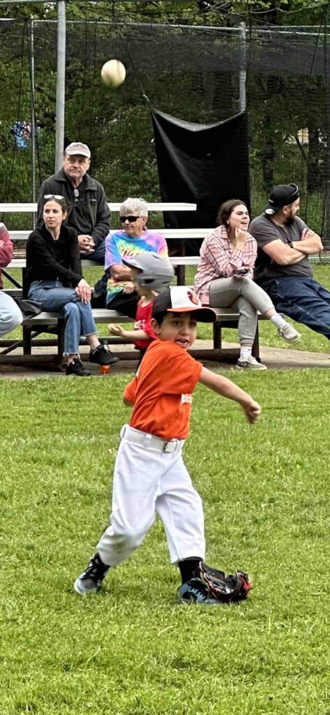 Axl Firkel is pictured throwing, nearly getting an out at First.