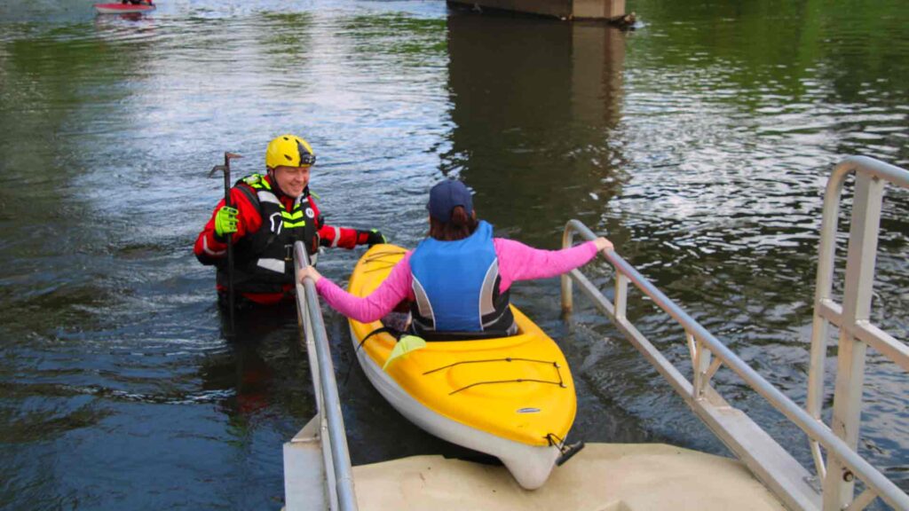 A participant in Float the Allegheny eases into the river from the launch at Steam Valley Road in Portville on Saturday. (Rick Miller/Olean Star)