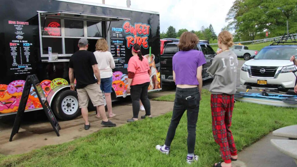People wait in line at a food truck at the put-in at Steam Valley Road in Portville for Saturday's Float the Allegheny.(Rick Miller/Olean Star)