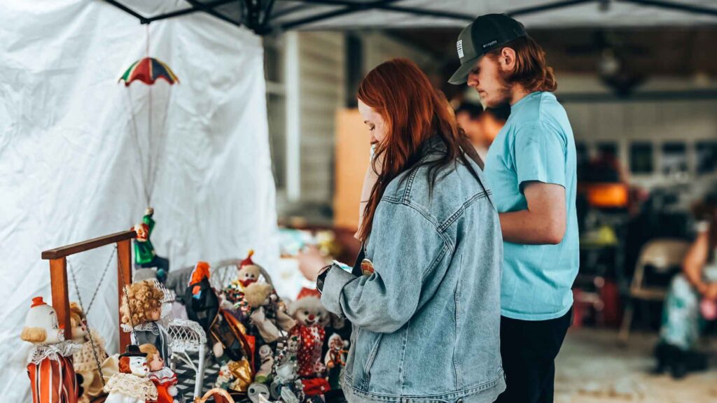  
Bradford Town Garage Sales — (Daniella Langianese/Star News Photo)
Despite intermittent rain showers, Bradford held their annual Town-Wide Garage Sale. Adapting with tents, or moving more indoors, sales were held Saturday, with some following-up on Sunday. On Saturday afternoon, at a sale on South 2nd Street in Derrick City, a couple of younger individuals checked out the wares for sale.
 
