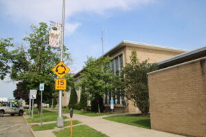 (Rick Miller/Olean Star) Former Olean Police Chief Michael Luty’s Hometown Heroes banner hangs outside the East State Street entrance to the Olean Police Station.