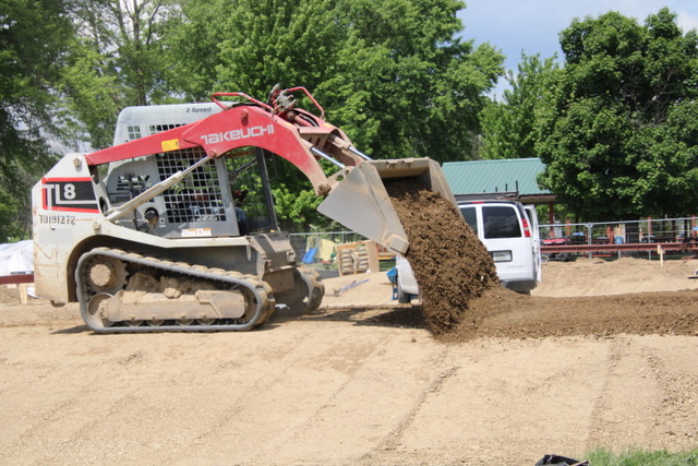 (Rick Miller/Olean Star)An employee of Grindline Skateparks of Washington State spreads soil at the site of the new Allegany Skate Park, now under construction at Allegany River Park on Union Street in Allegany. The park should be ready in August or September.