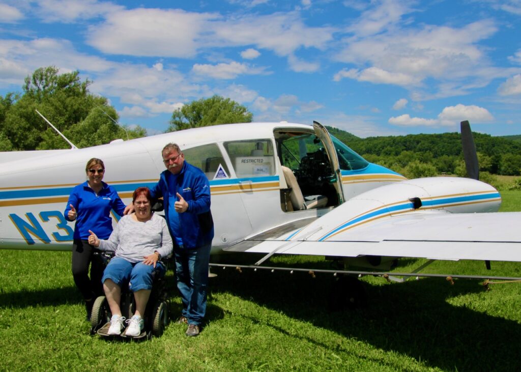(Rick Miller/Olean Star) The Duflo Family, Brittany, Renee and Jeff, are pictured giving a thumbs up gesture in front of the Piper Aztec airplane he uses for aerial spraying for mosquitoes and other insects at the Great Valley Airport Wednesday.