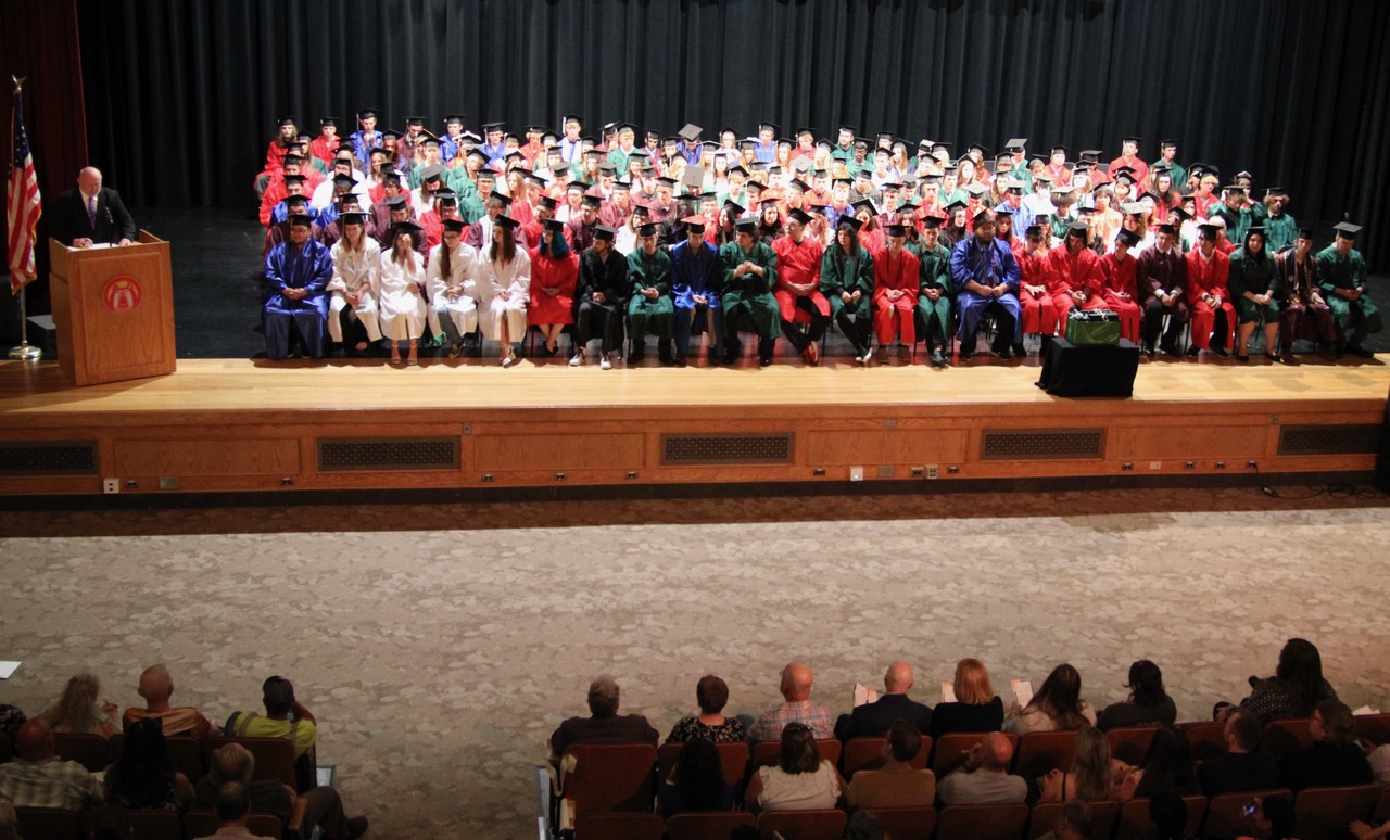 (Rick Miller/Olean Star) CA BOCES Olean Career Technical Education Center graduates listen to Olean CTE Building Principal Noel Shelly at commencement exercises Friday night in the Olean High School auditorium.