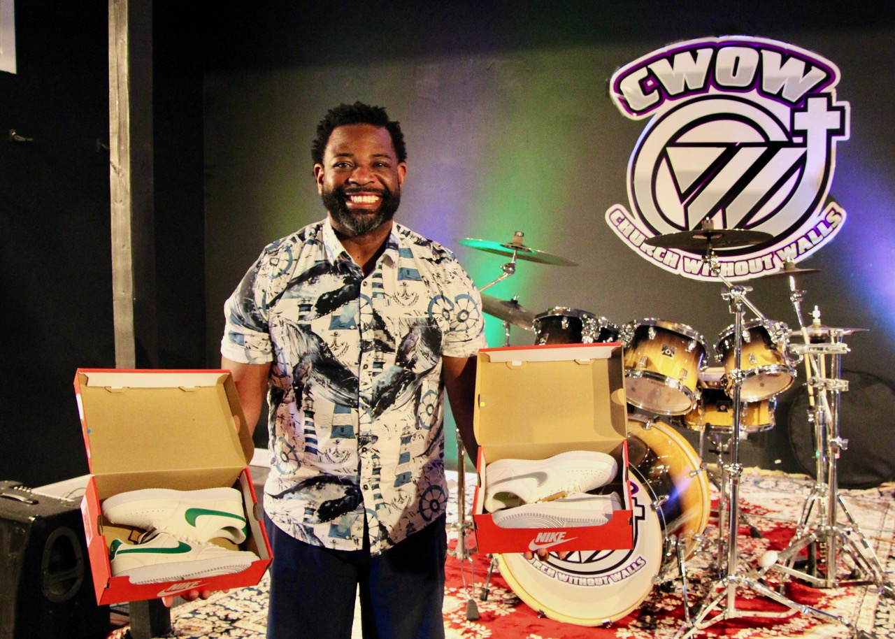 (Rick Miller/Olean Star) Pastor Tyrone Hall of the Church Without Walls holds boxes of sneakers that have already been donated for Feet Heat 5, the church’s annual sneaker giveaway for area youths.