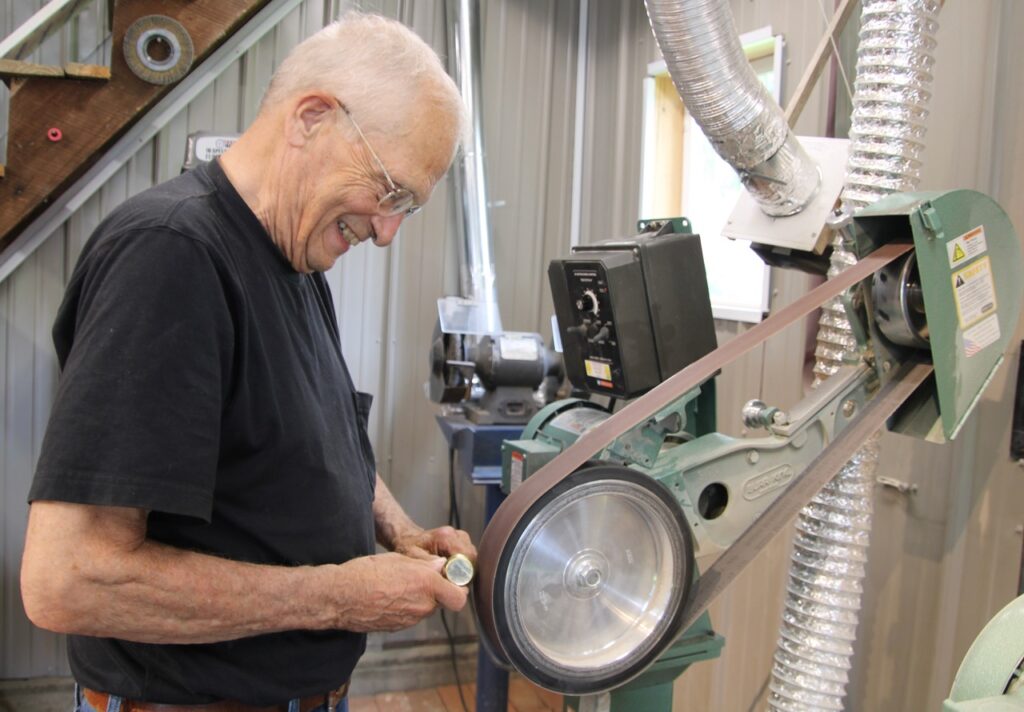 (Rick Miller/Olean Star) John Burrell, who formerly ran Burrell Cutlery in Ellicottville, polishes a knife handle in his Ellicottville shop for this weekend’s Village of Knives at the Cattaraugus County Fairgrounds. It will be one of the largest knife shows in the country. There were once more than 60 cutleries within 50 miles of Little Valley.