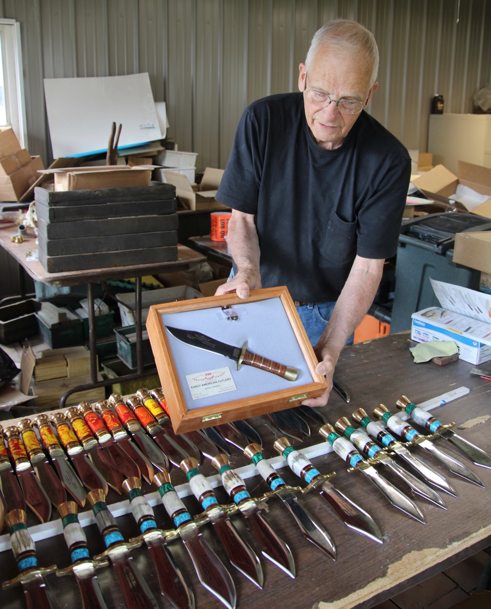 (Rick Miller/Olean Star) John Burrell, the last of the Case Family making knives in his Ellicottville shop, displays a collectible knife is a glass topped rosewood case.Burrell, the mayor of Ellicottville, and dozens of others will be selling their knives this weekend at Village of Knives at the Cattaraugus County Fairgrounds. Burrell will also be selling knives of his late wife, Sheila.