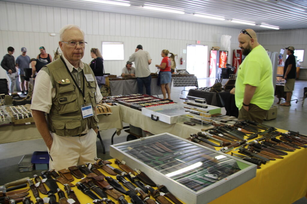 (Rick Miller/Olean Star) Mike Spors, a knife collector from Janesville, WI, buys and sells pocket knives, hunting knives and straight razors. He said attendance was good on opening day of Village of Knives at the Cattaraugus County Fairgrounds in Little Valley.
