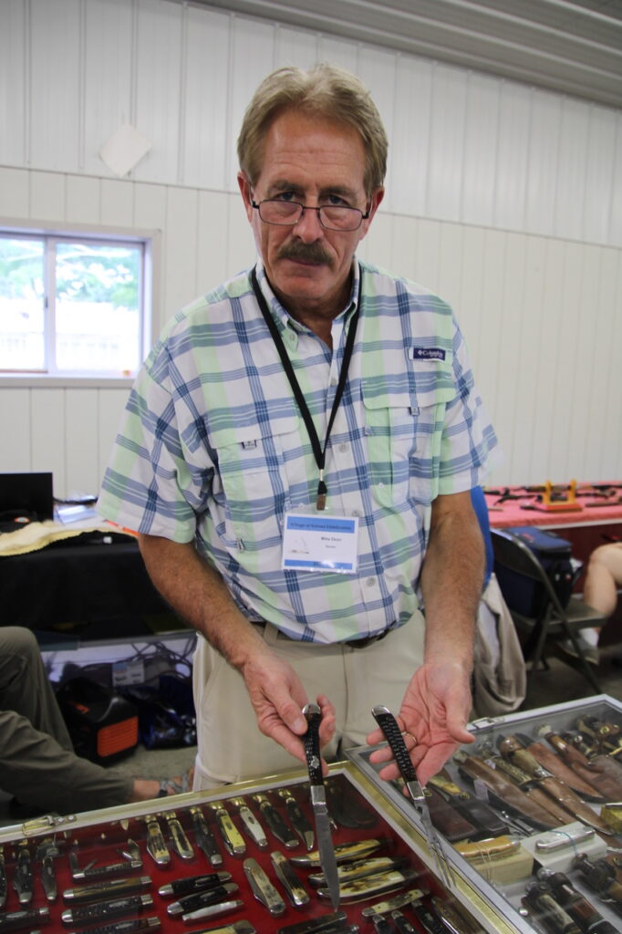 (Rick Miller/Olean Star) Knife collector Michael Dean of Greencastle, IN, displays a Ka-Bar knife made in Olean that comes apart for use as a knife and fork.