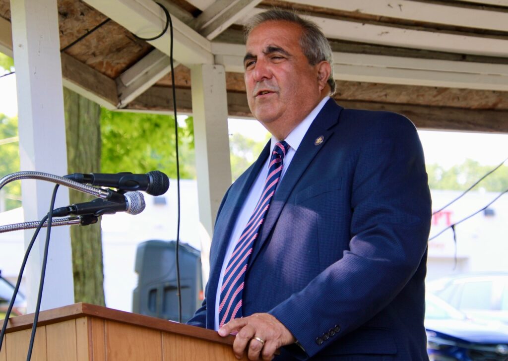 (Rick Miller/Olean Star)  Assemblyman Joseph Giglio speaks during the dedication of the Hinsdale Vietnam Memorial Saturday. The assemblyman said his elder brother Nick, who served in Vietnam later died of Agent Orange.
