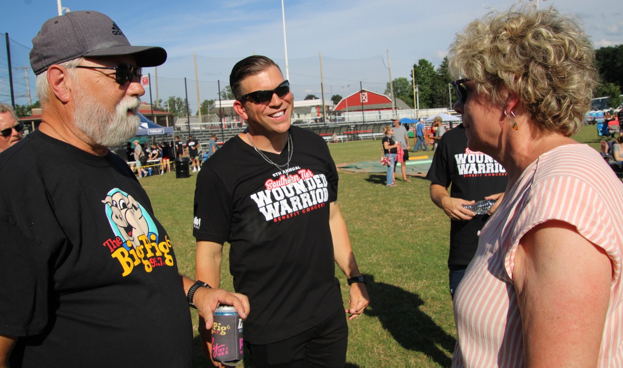 (Rick Miller/Olean Star) Col. Patrick Miller (center), speaks with WPIG Radio personality Gary Neese (right) and Barbara O’Brien at the Southern Tier Wounded Warrior Concert he hosted at Bradner Stadium July 20.