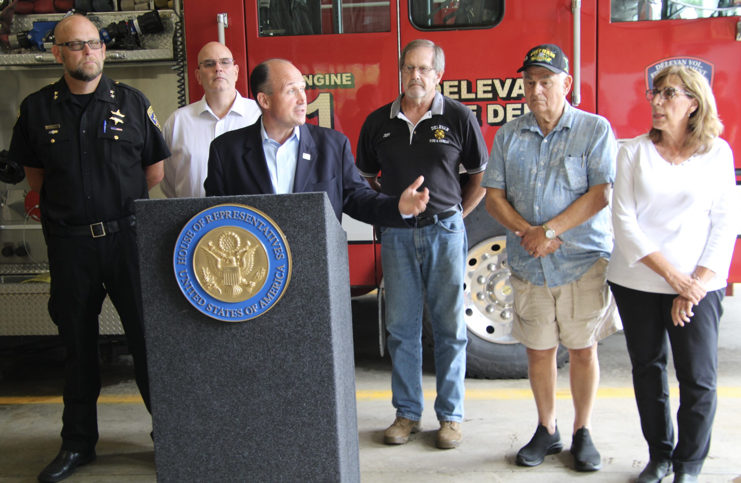 (Rick Miller/Olean Star) U.S. Rep. Nick Langworthy (at podium), flanked by public officials, announced a $108,594 grant to the Delevan Fire Department for new turnout gear. Others (from left) are: Cattaraugus County Acting Sheriff Eric Butler, Republican Party Chairman Mark Heberling, Delevan Fire Chief Jeff Holmes, Mayor John Stumpf and Yorkshire Supervisor Marcia Lexer.