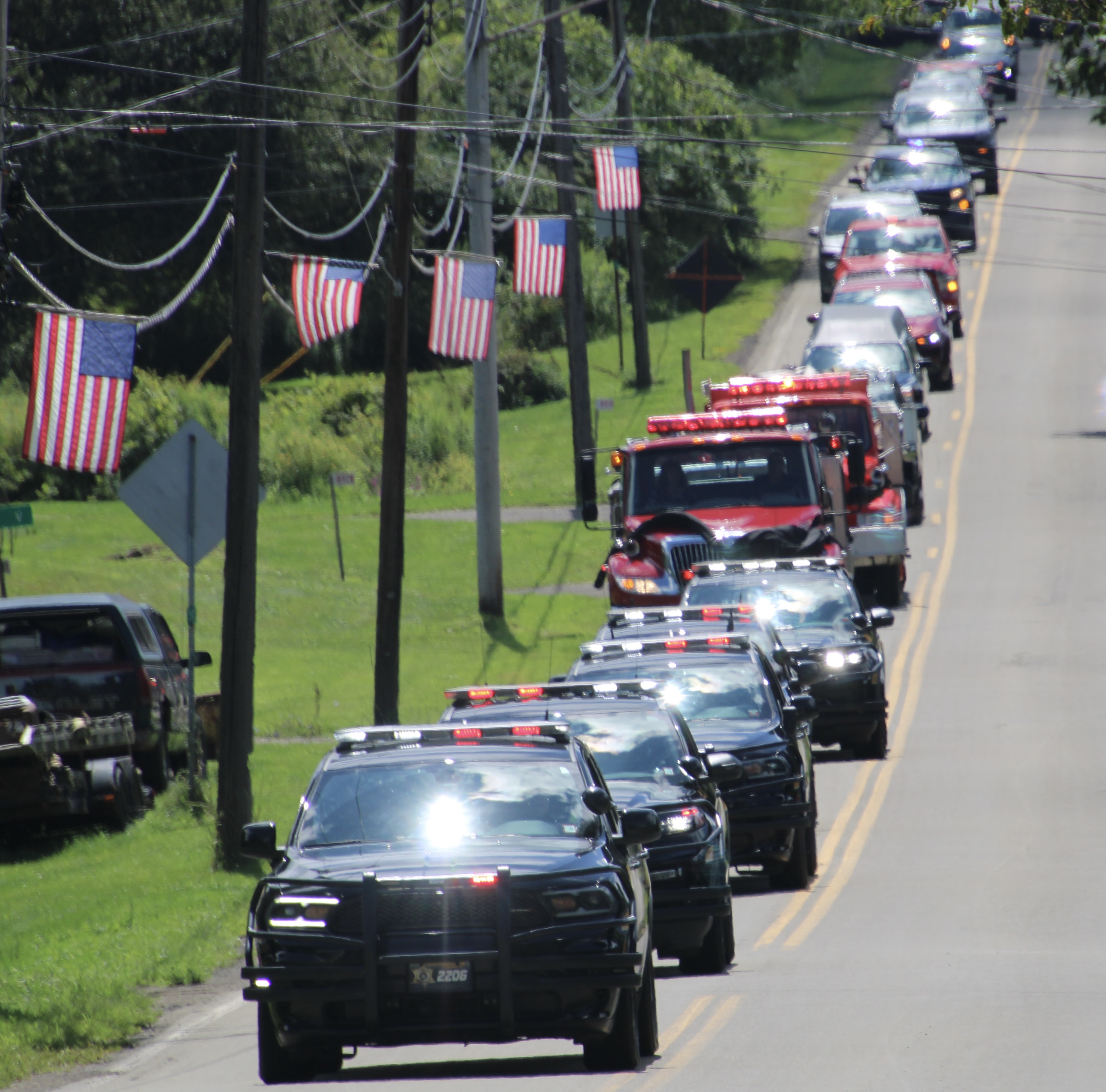 (Rick Miller/Olean Star)  A procession of sheriff's and fire service vehicles escorted the body of Tim Lexer from the Little Valley funeral home to his home community of East Otto on Wednesday. The former firefighter and chief was also a sheriff's dispatcher.