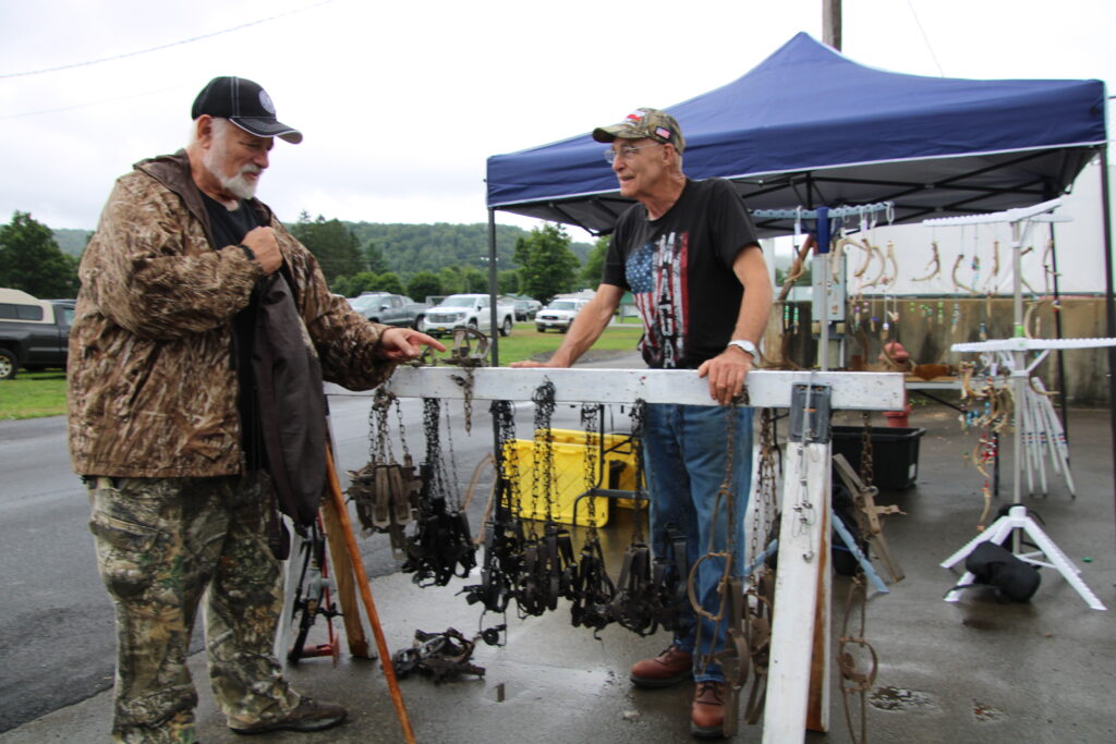 (Rick Miller/Olean Star) Trapping supplies vendor Bill Blanchard of Mayville (right), speaks with Jim Colosimo of Slippery Rock, Pa. on opening day of the Sportsmen's Rendezvous, sponsored by the Cattaraugus County Trapper's Association.