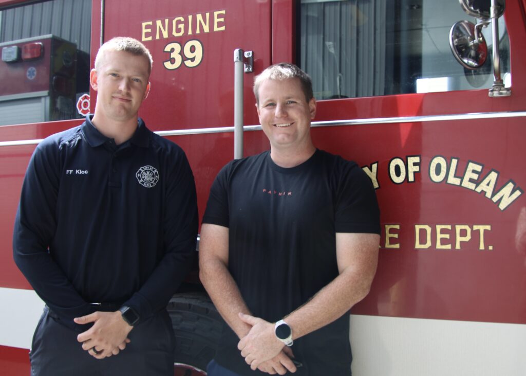 (Rick MIller/Olean Star)  Co-directors of the City of Olean Fire Department's Swift Water Team Firefighter Colin Kloc and Capt. Bryan Swift stand next to a fire truck at the Central Fire Station. They were part of a team of four deployed last Friday to Pennsylvania flooding from Tropical Storm Debbie.
