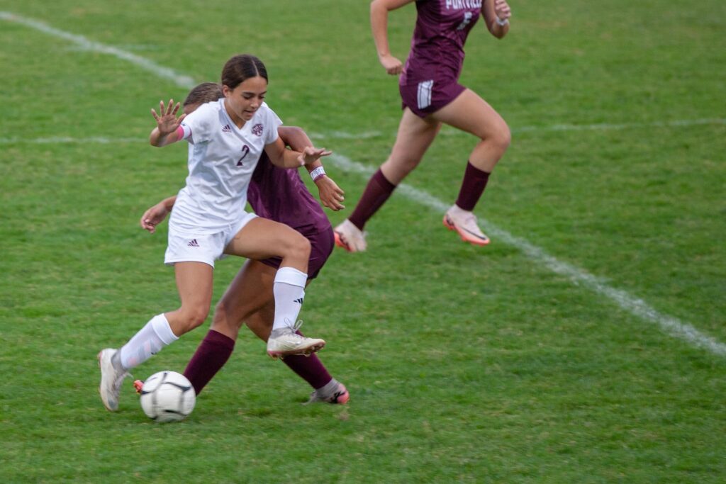 Addie-John-from-Ellicottville-leaps-through-the-air-to-get-around-a-Portville-defender-9-26-24.