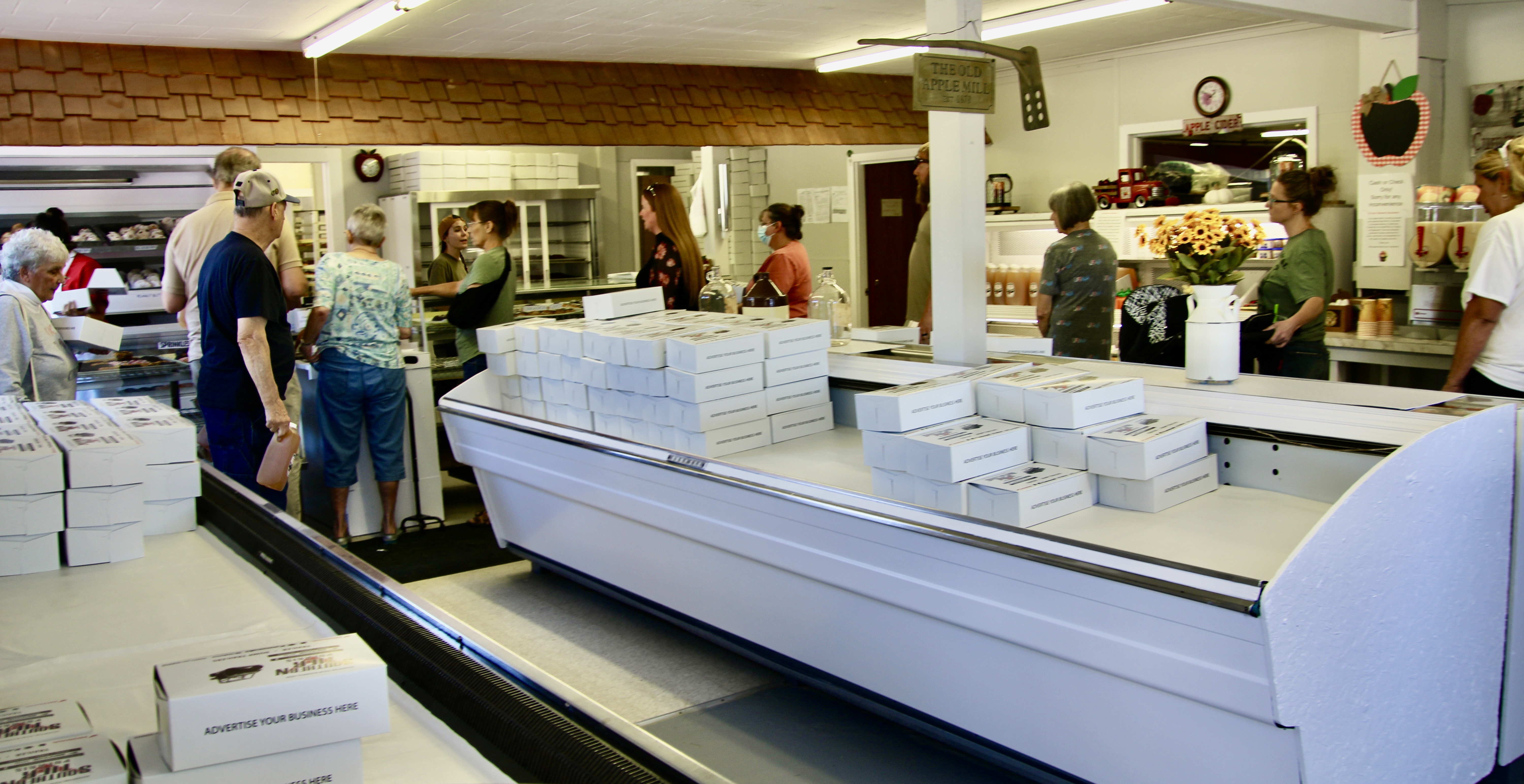 (Rick Miller/Olean Star)  The line of customers inside Cummins Cider Mill when it reopened Wednesday in Portville wound through retail area and out the door.