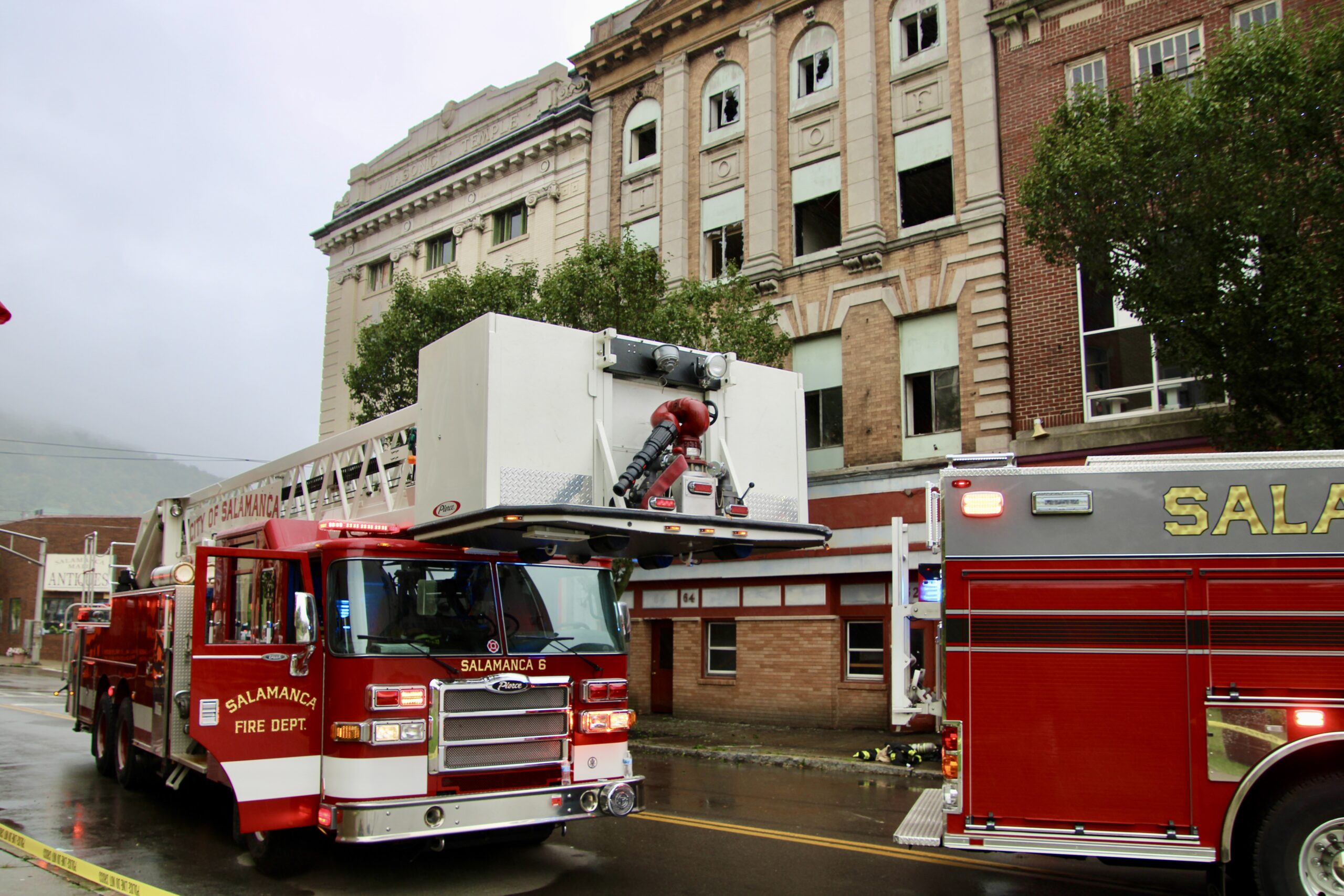 (Rick Miller/Olean Star) City of Salamanca fire engines, including a ladder truck, are parked across from 64-62 N. Main St. Monday morning where a fire broke out about 8:30 a.m. The fire, of possible electrical origin, was brought under control with aid from seven neighboring fire companies.