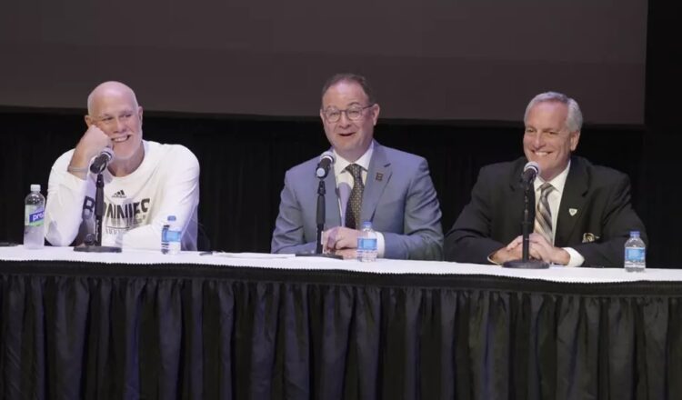 (Photo: Adrian Wojnarowski, center, talks alongside head coach Mark Schmidt and Director of Athletics Bob Beretta Wednesday. Photo by Danny Bush for St. Bonaventure)