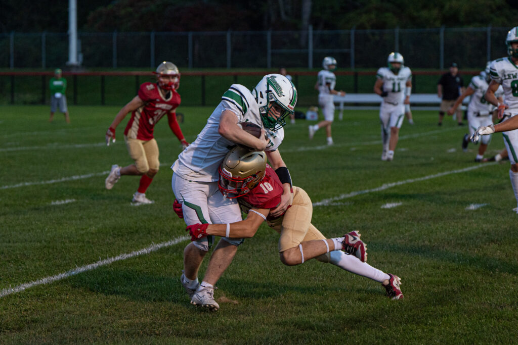 Photo by Hunter O. Lyle  Olean’s Austin Miles wraps up Lewiston Porter’s Jackson Courts during the Huskies’ 29-7 win on Friday. 