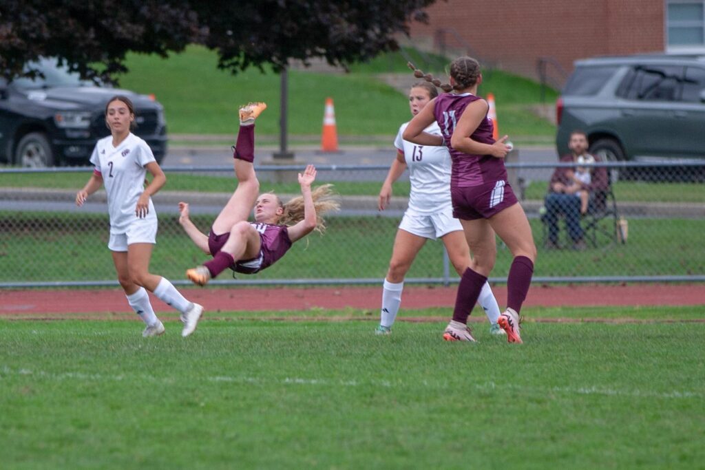 Portvilles-Grace-Gariepy-flys-through-the-air-on-an-attempted-wheel-kick-as-Elliocottviles-Addie-John-2-and-Drew-Ficek-13-look-on