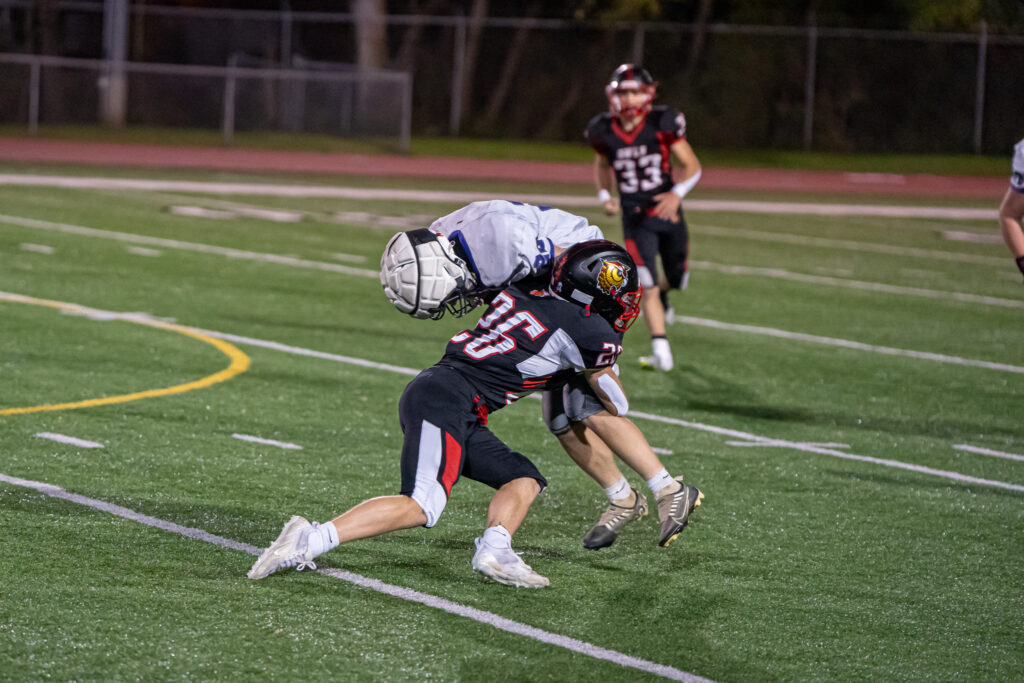 Photo by Hunter O. Lyle  Jordan Thompson spears a Falcon’s receiver during the Owls’ win over Coudy on Senior Night. 