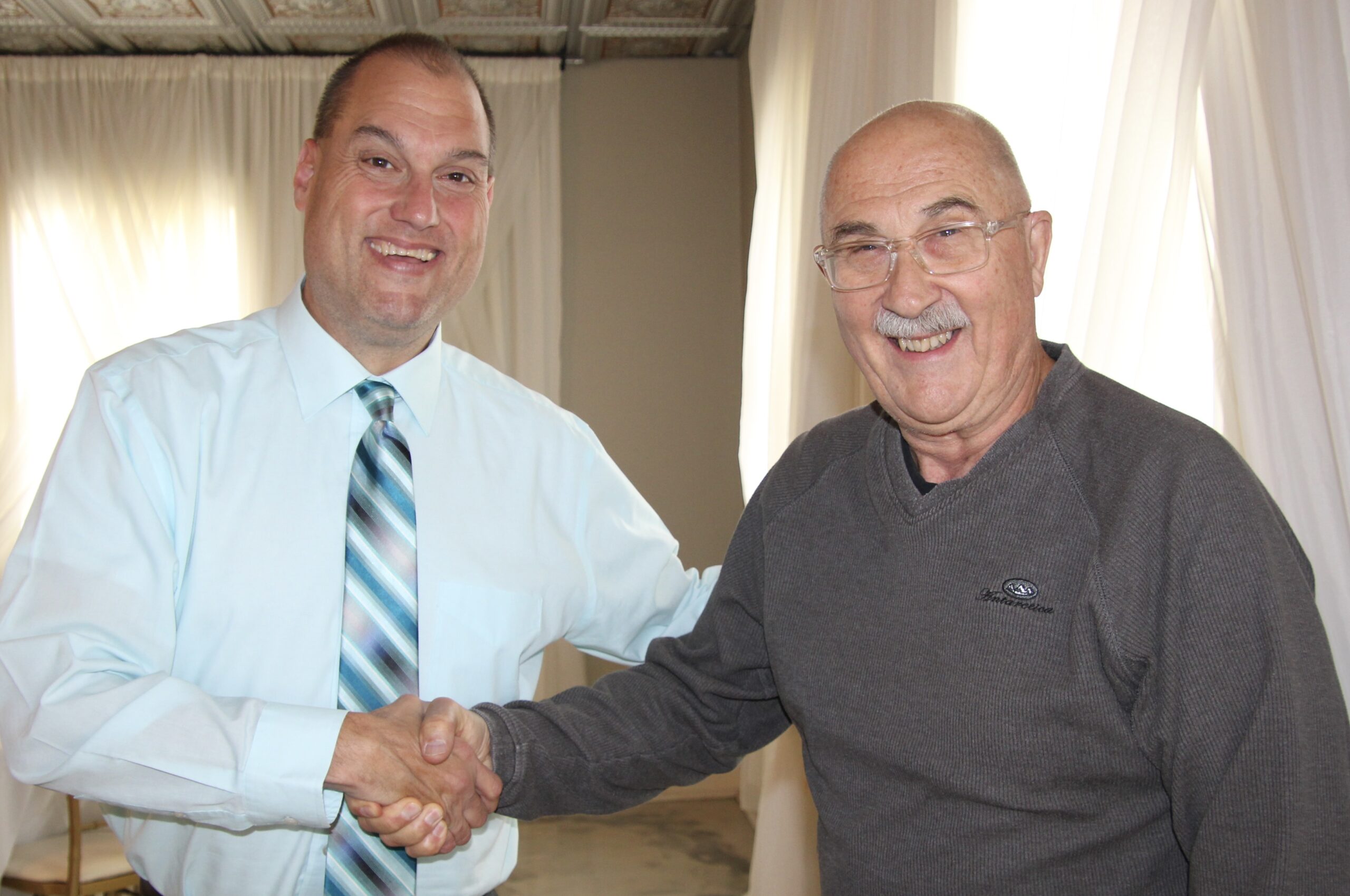 (Rick Miller/Olean Star) Cattaraugus County Board of Health President David Smith (left) welcomes the board’s newest member Wednesday, Dr. George Spigel.