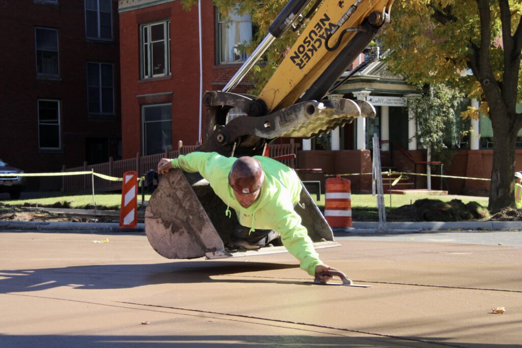 (Rick Miller/Olean Star)  East State Street traffic was still one-way Thursday as Millennium Construction was finishing up work on the mini-roundabout at East State and Barry streets. Paving was completed Wednesday.