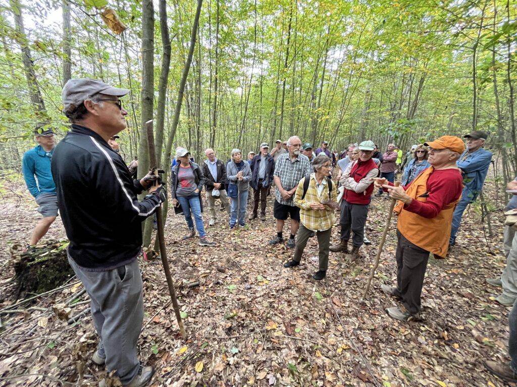(Rick Miller/Olean Star) Jim Brady talks with participants of Saturday's Woods Walk at his Indiana Avenue woodlot where dozens of near-extinct American chestnut trees have been discovered over the past year.