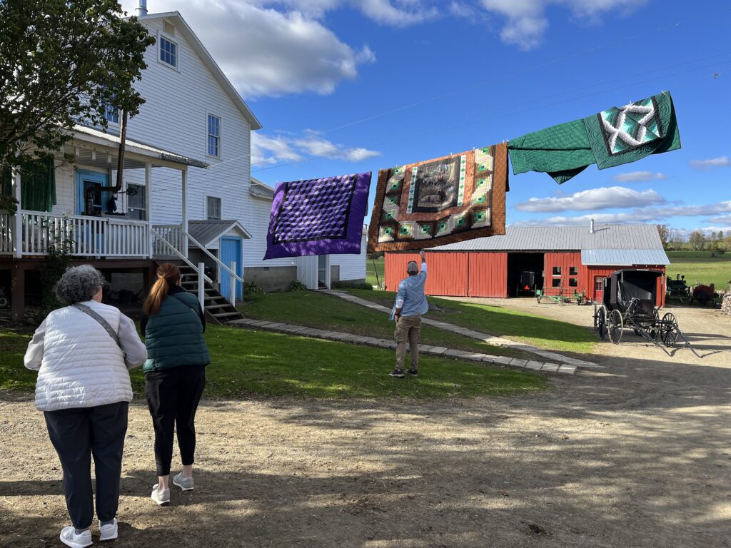 (Rick Miller/Olean Star)  Quilts hang in the breeze outside Anna's Quilts on Pigeon Valley Road in Cattaraugus.