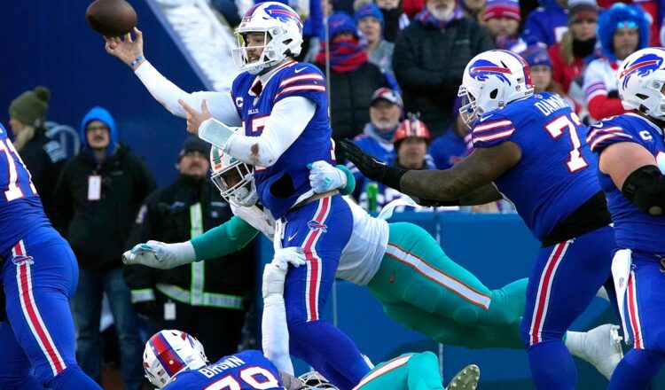 (Cutline: Josh Allen being protected by Dion Dawkins and Spencer Brown, is 12-2 versus Miami, with 37 touchdown passes in 14 games and five rushing touchdowns. Rick Scuteri photo)