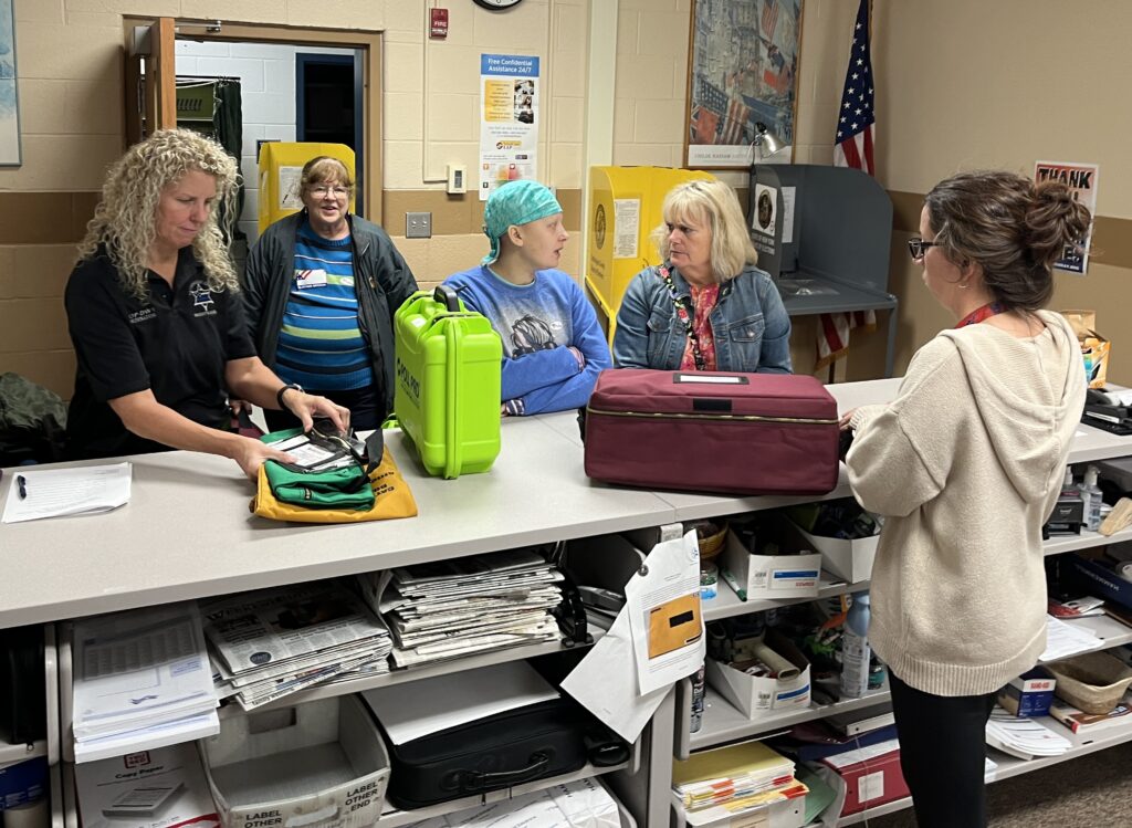 (Rick Miller/Olean Star) Cattaraugus County election officials receive election materials at the Board of Elections office in Little Valley after polls closed Tuesday night.