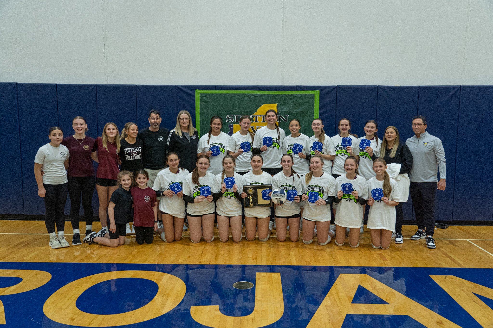 After sweeping Falconer, the Portville volleyball team poses with their Section VI Class C Champion plaque. | Photo by Hunter O. Lyle