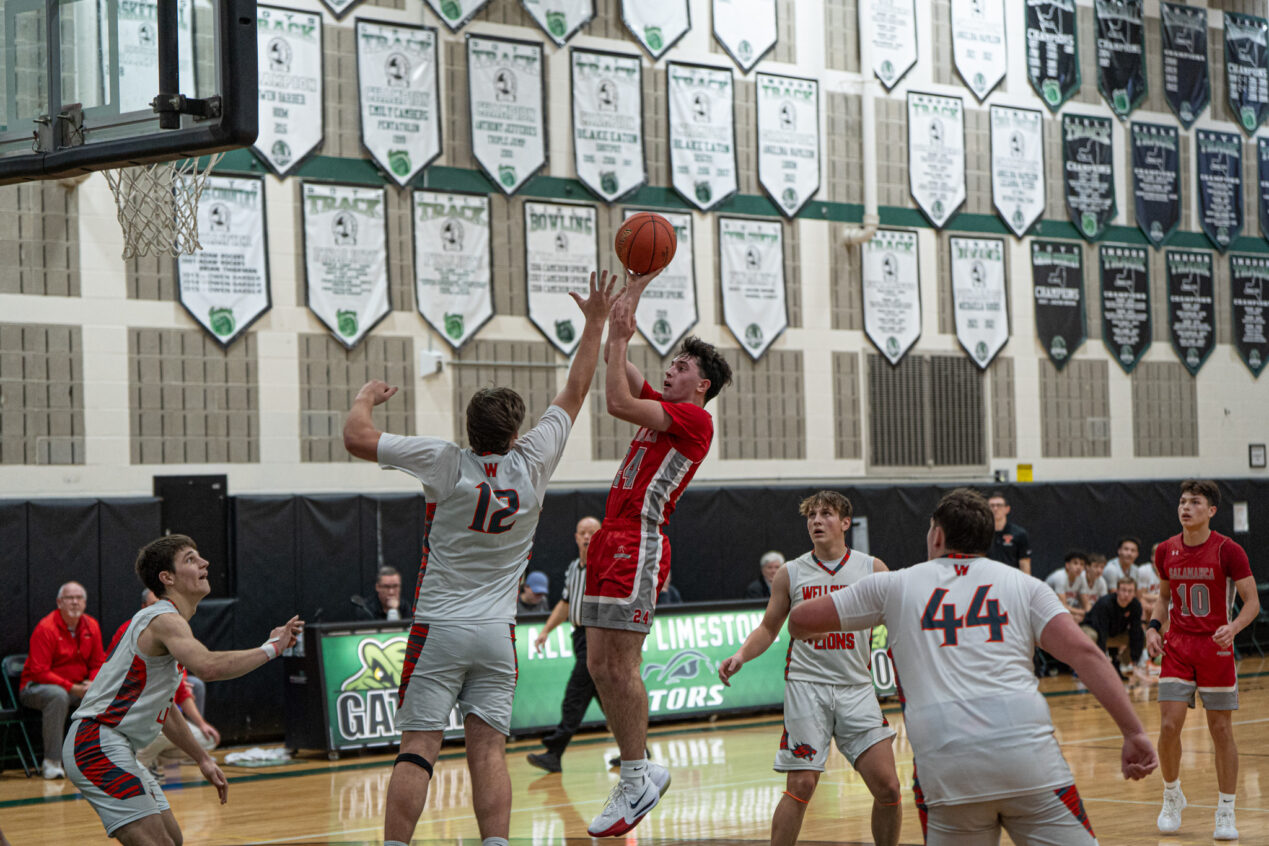 Salamanca's Corey Holleran pulls up for a contested jumper during the Warriors' loss to Wellsville last Saturday. | File photo by Hunter O. Lyle