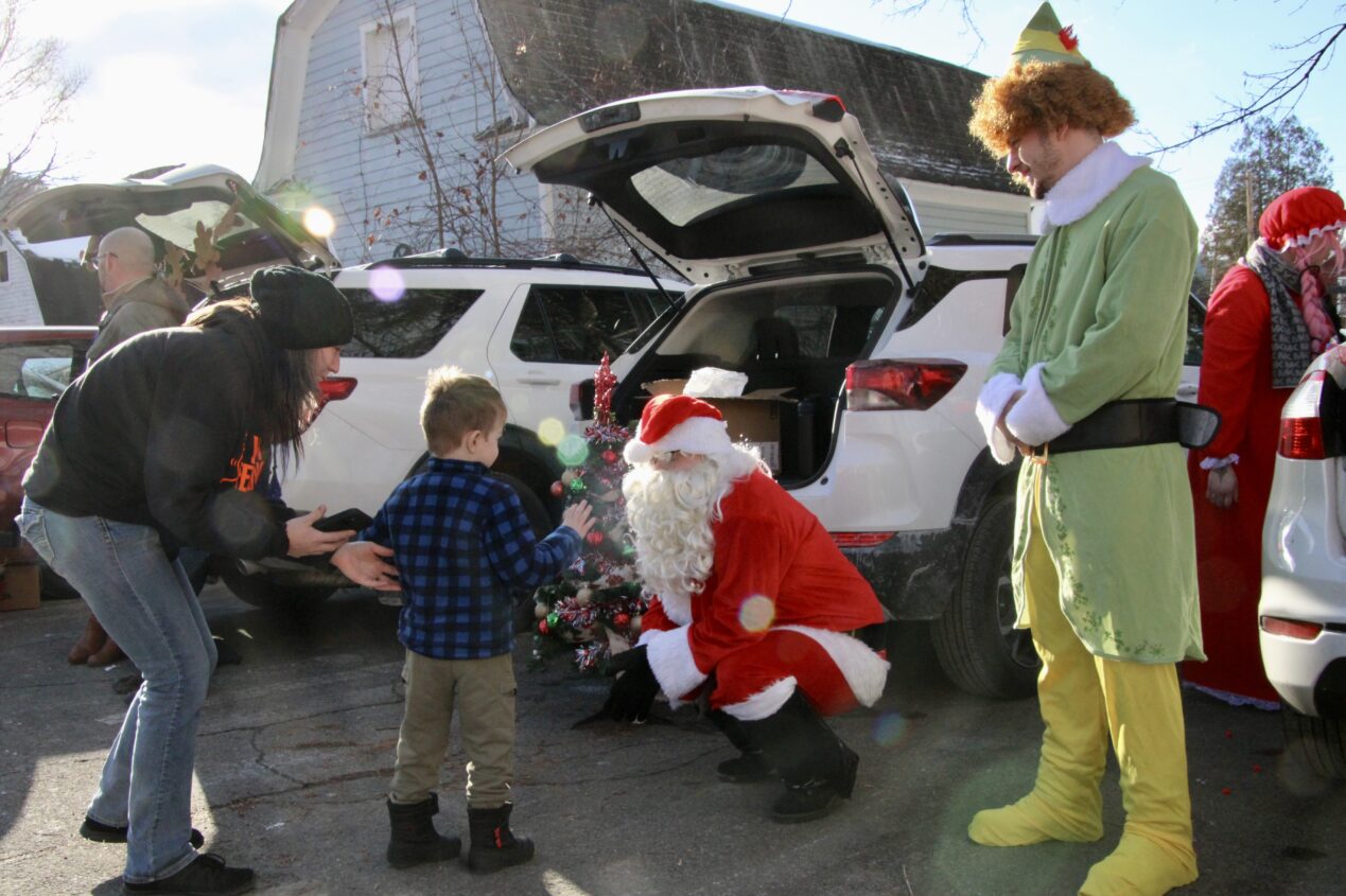 (Rick Miller/Olean Star) A child approaches Santa Friday afternoon at the Santa's Carnival Trunk & Treat at Connecting Communities in Action (CCA) in Salamanca. The annual event was held outside for the first time in 15 years due to renovations.