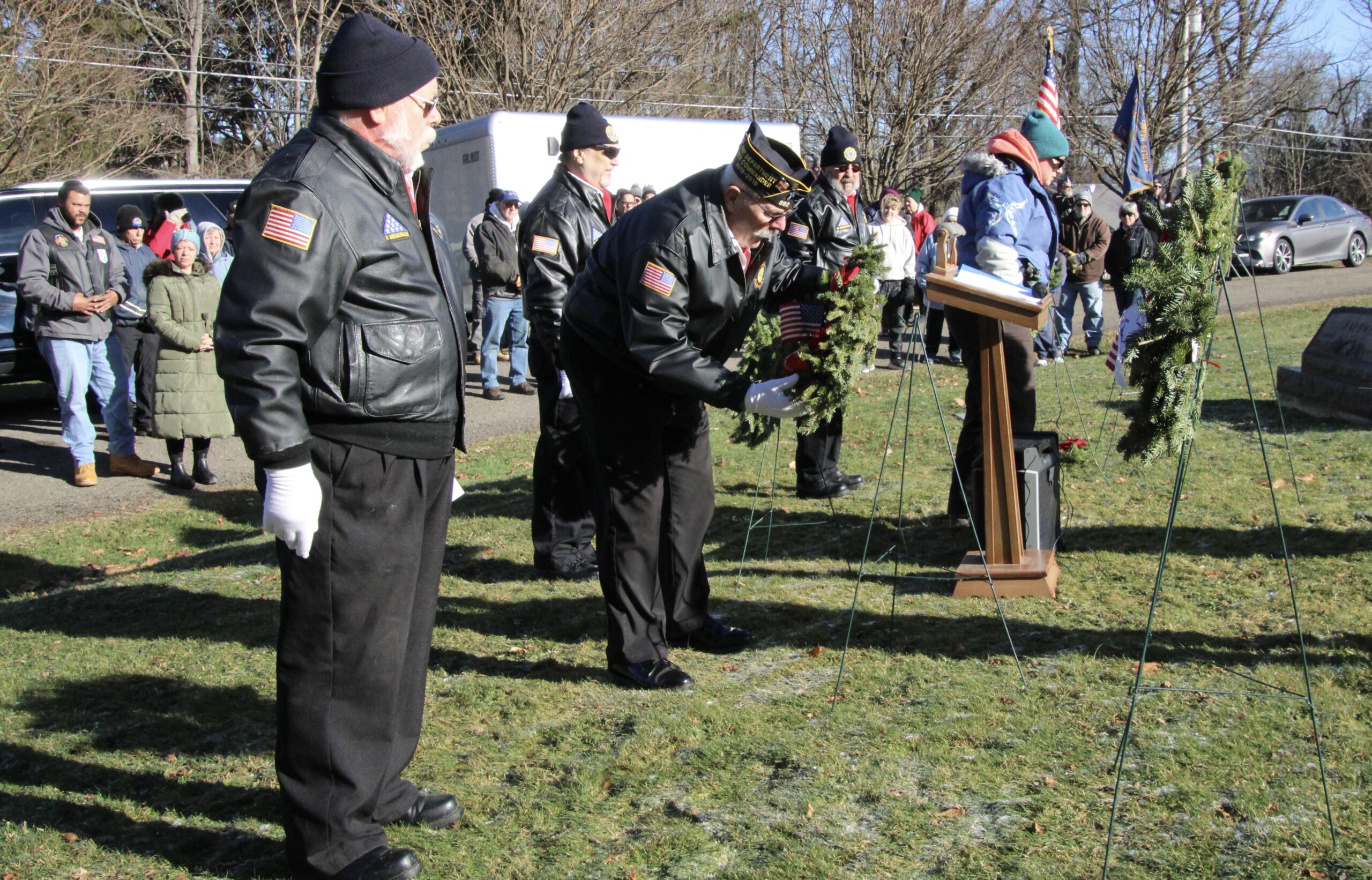 (Rick Miller/Olean Star) Members of the Allegany American Legion Ri\tual Team place wreaths on holders at a Wreaths Across America program at Mount View Cemetery Saturday. Volunteers place 456 wreaths at veterans graves.