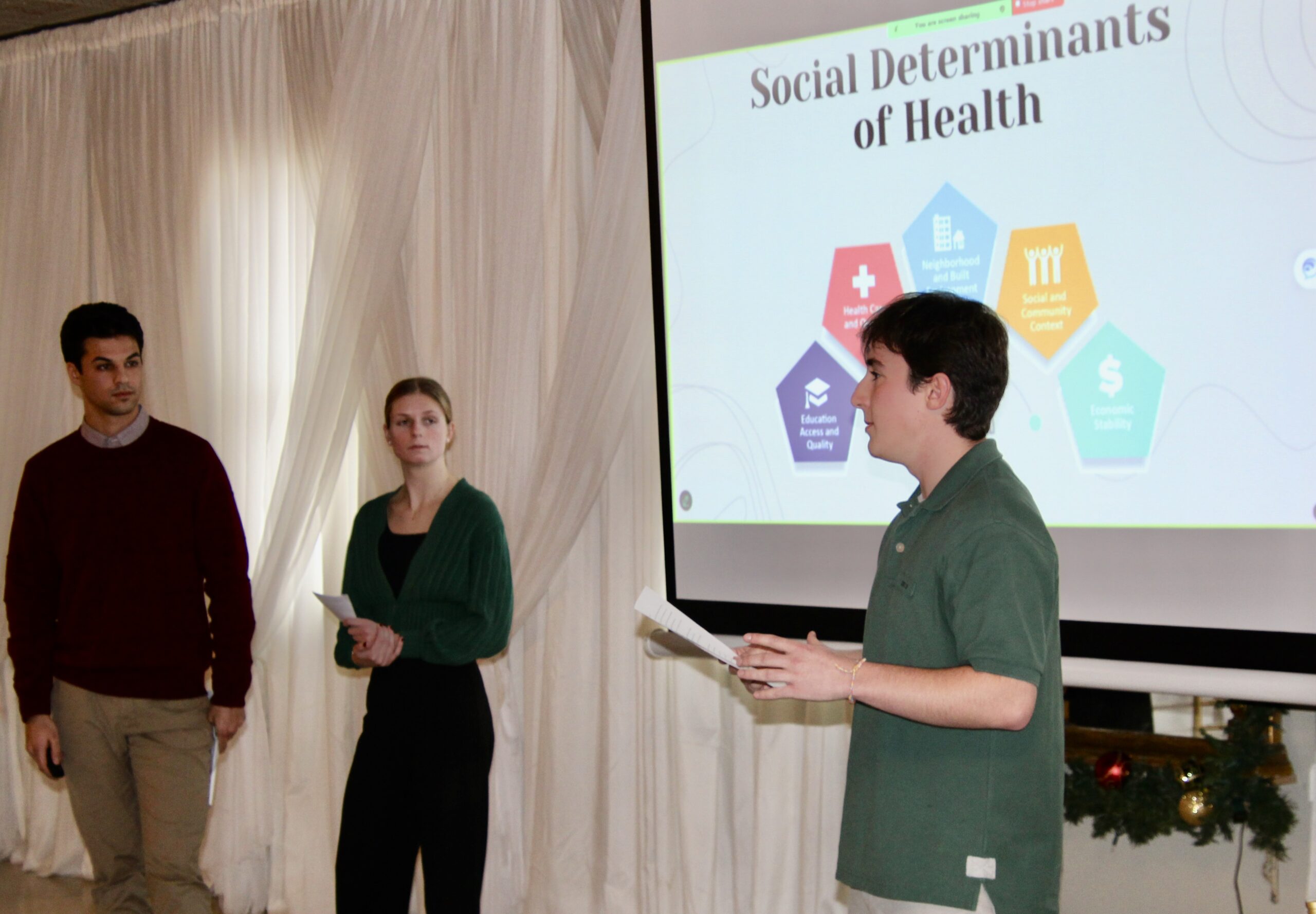 (Rick Miller/Olean Star) St. Bonaventure public health students (from left) Ben Vitale, Molly Gipson and Kevin Eberth present their findings on Social Determinants of Health in Cattaraugus County to members of the Board of Health on Wednesday.