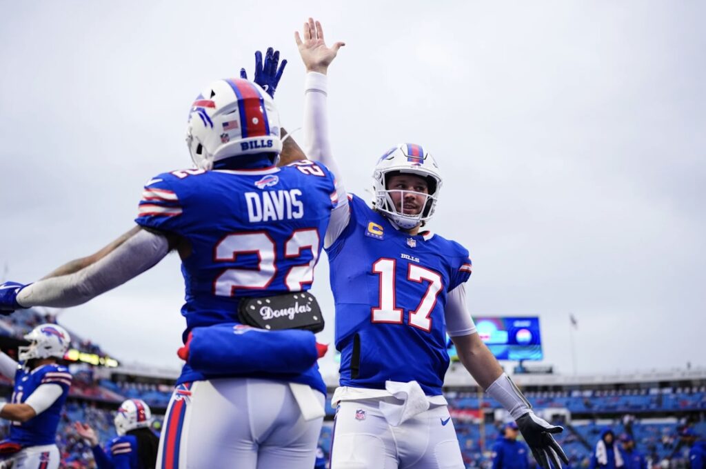 Cutline: Josh Allen and Ray Davis connect on a high-five during the win over the Jets on Sunday. Allen connected on two touchdown passes and ran for a third. Ben Green/Buffalo Bills photo