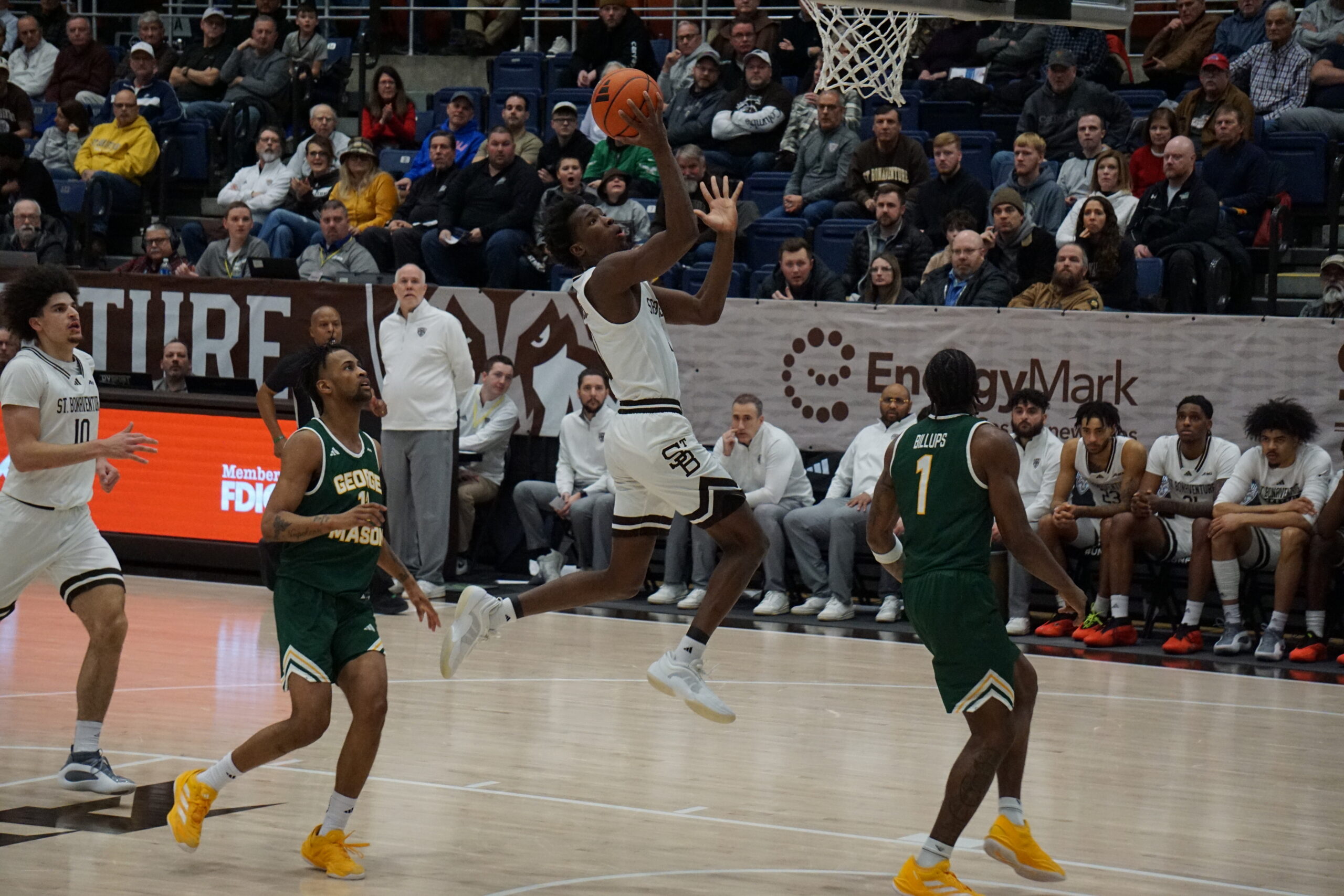 St. Bonaventure guard Melvin Council Jr. (11) hangs in the air as he attempts to finish off a fast break layup ahead of his George Mason defender. Council led the Bonnies with a game-high 18 points in their 75-62 loss to the Patriots. (Spencer Bates)