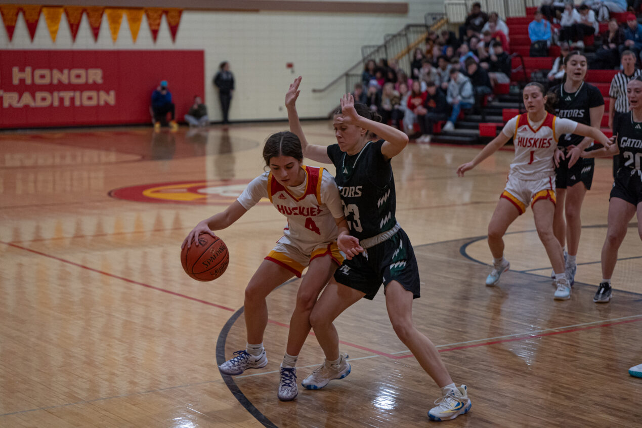 Alaina Hirliman (left) backs down Addie Fisher during the Lady Huskies' eighth straight loss. | Photo by Hunter O. Lyle