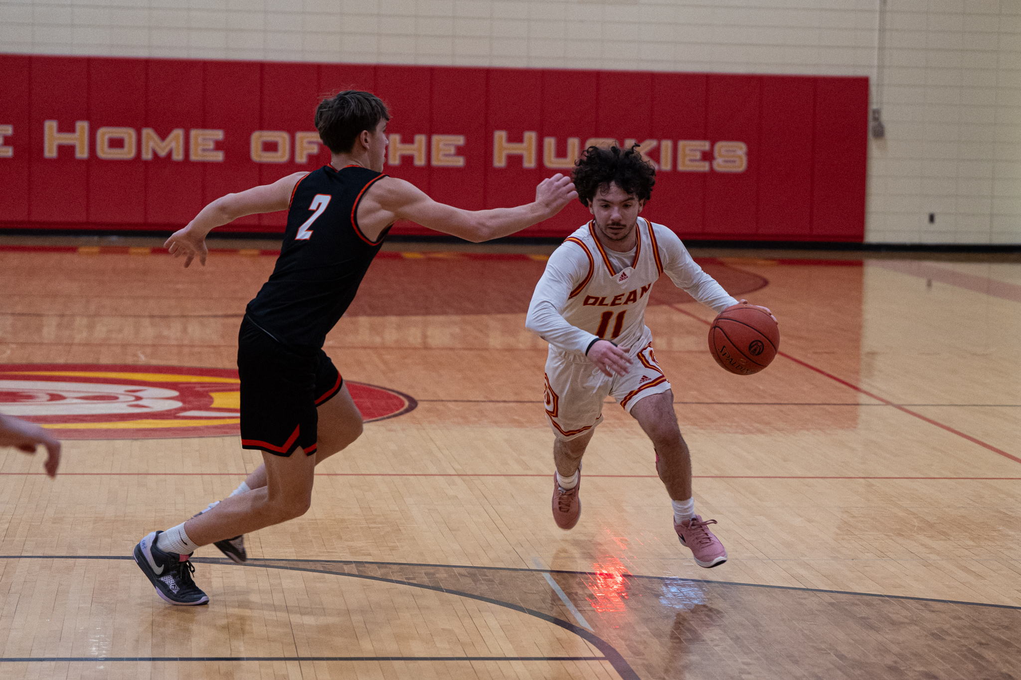 Olean's Luca Quinn drives through the lane towards the basket during the Huskies' 63-59 win over Fredonia. Quinn would come up with the game-winning steal and score with 20 seconds left. | Photo by Hunter O. Lyle