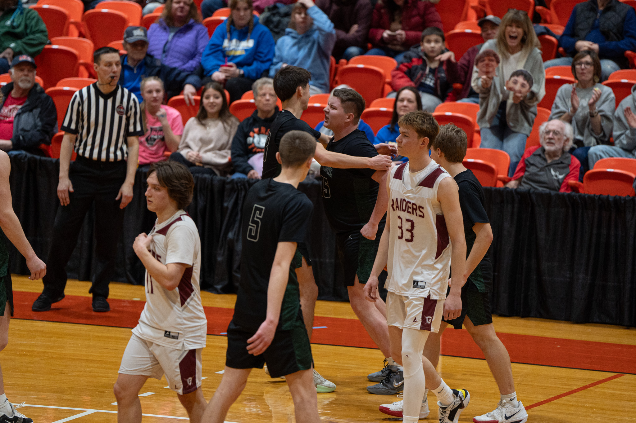 After pulling down the game-sealing offensive rebound, Caleb Strade (35, right) embraces Carson Kwiatkowski (13, left) as the Gators earned a spot in the Section VI Class B2 championship. | Photo by Hunter O. Lyle