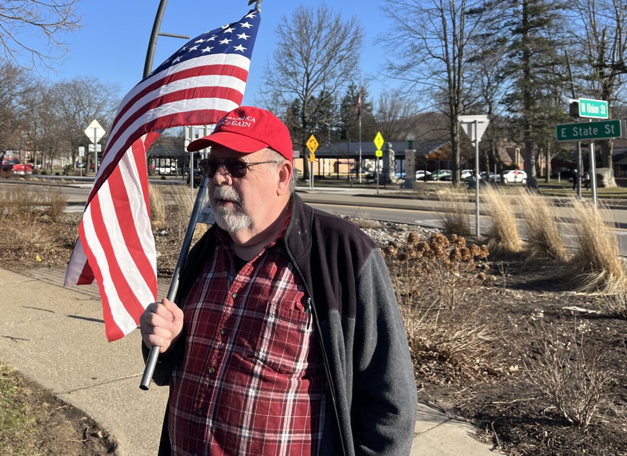 (Rick Miller/Olean Star) A flag waving Dave Neeley of Olean staged two counter demonstrations Tuesday across from Lincoln Park.