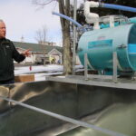 (Rick Miller/Olean Star) Randy Sprague, owner of Sprague Maple Farms watches over a valve that releases sap from the plastic tubing into a tank behind Sprague’s Restaurant.