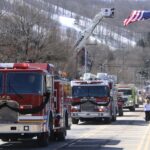 (Rick Miller/Olean Star) A procession of fire trucks and emergency vehicles escorted the body of fallen Ellicottville firefighter and paramedic to Holy Cross Cemetery Friday following funeral services at the Ellicottville Town Center.