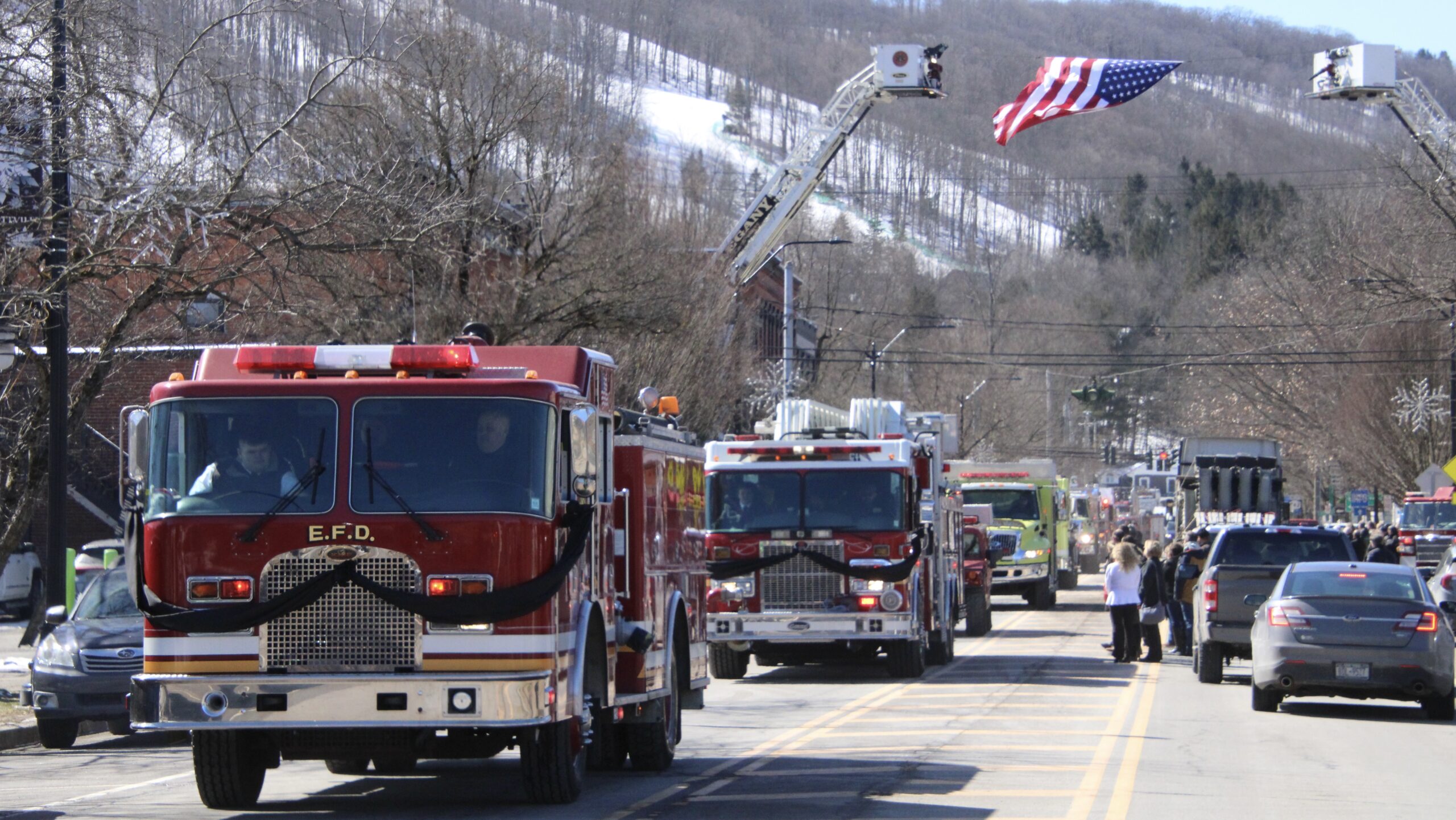 (Rick Miller/Olean Star) A procession of fire trucks and emergency vehicles escorted the body of fallen Ellicottville firefighter and paramedic to Holy Cross Cemetery Friday following funeral services at the Ellicottville Town Center.