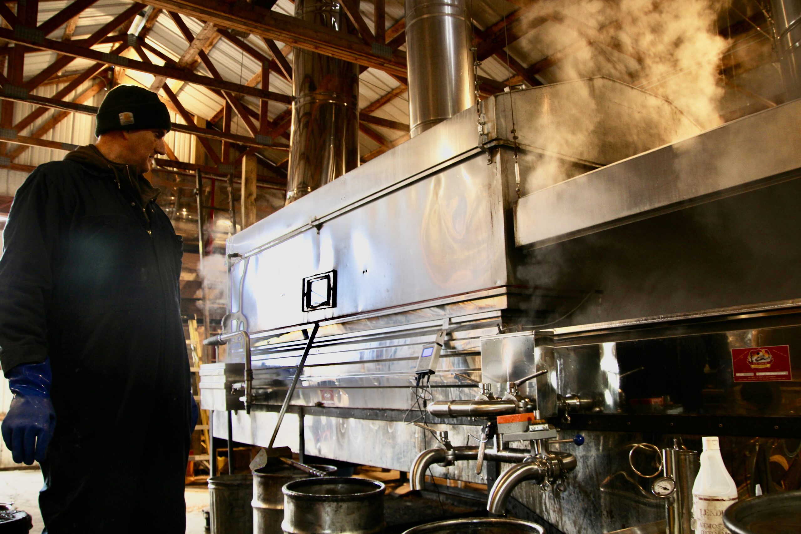 (Rick Miller/Olean Star) Bob Wright of Wright’s Farms, Farmersville, keeps watch over the wood-fired evaporator boiling down maple sap into syrup in the farm’s sugar house on Laidlaw Road. The farm has been making maple syrup since 1840.