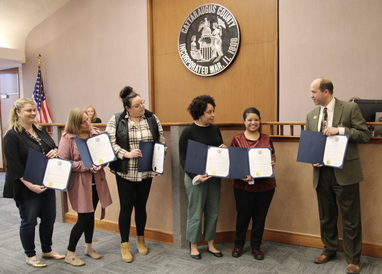 (Rick Miller/Olean Star) Cattaraugus County Legislature Chairman Andrew Burr (right), presented recognition certificates for five Olean Pines staff members who recently saved the life of a nursing home visitor by performing CPR. Staff (from left) are: April Crisfulli, in-service coordinator; Stacy Allen, assistant director of nursing; Brandi Ferris, license practical nursing supervisor; Atiya Milliner, head nurse, and Autumn Benson, licensed practical nurse.