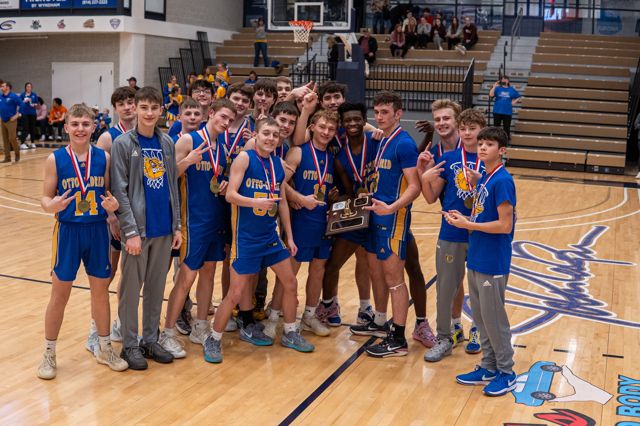 The Otto-Eldred boys' basketball team celebrates with their new hardware after finally winning their long-awaited District 9 championship. | Photo by Hunter O. Lyle