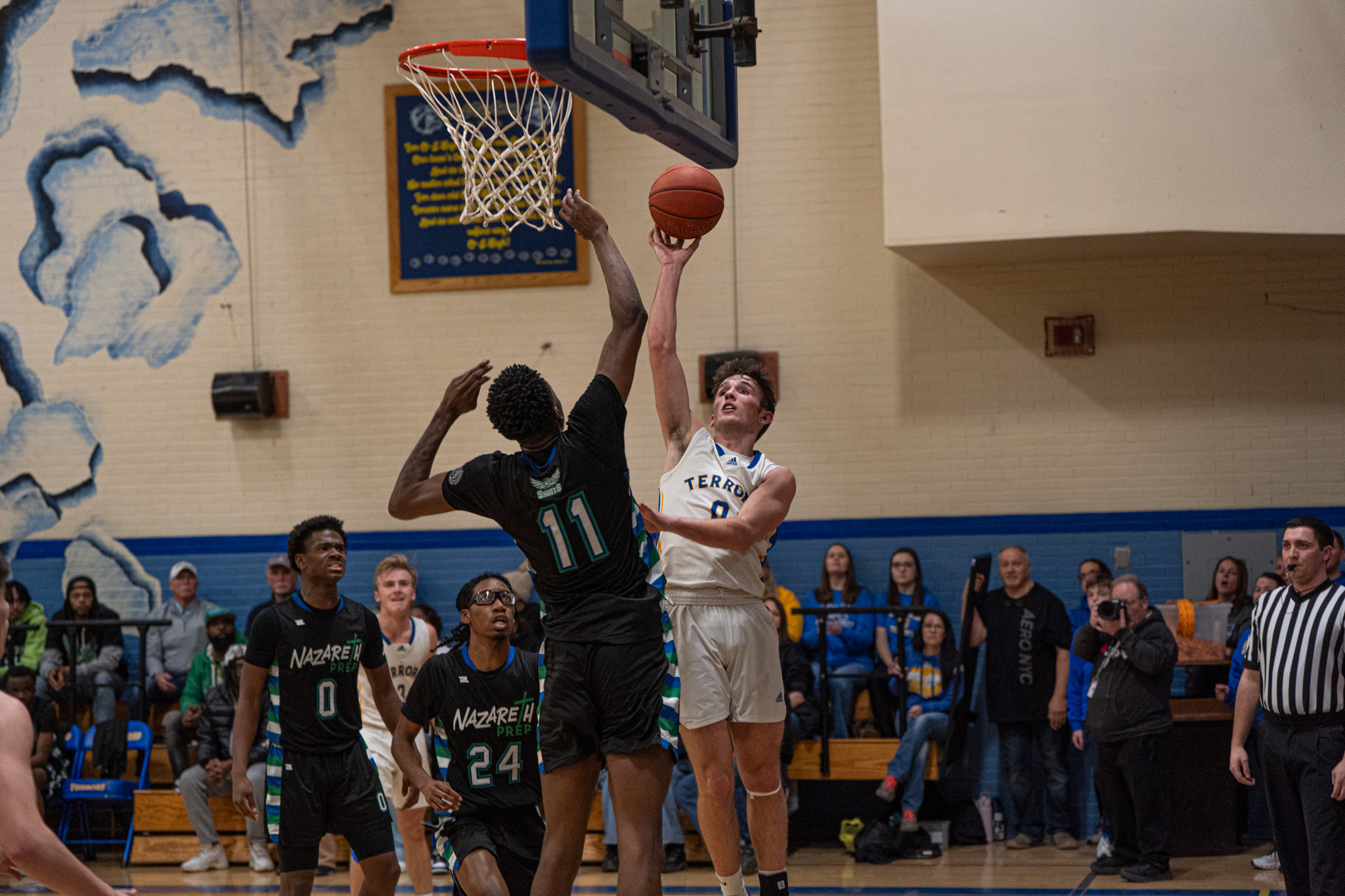 Otto-Eldred's Manning Splain rises up to score over Nazareth Prep's 6'7 Willie Evans. Splain ended with a game-high 26 points as the Terrors move on to the PIAA quarterfinals. | Photo by Hunter O. Lyle